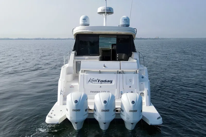 Slide: The Image of 2020 Regal 38 XO yacht with triple Yamaha engines on open water. - 4