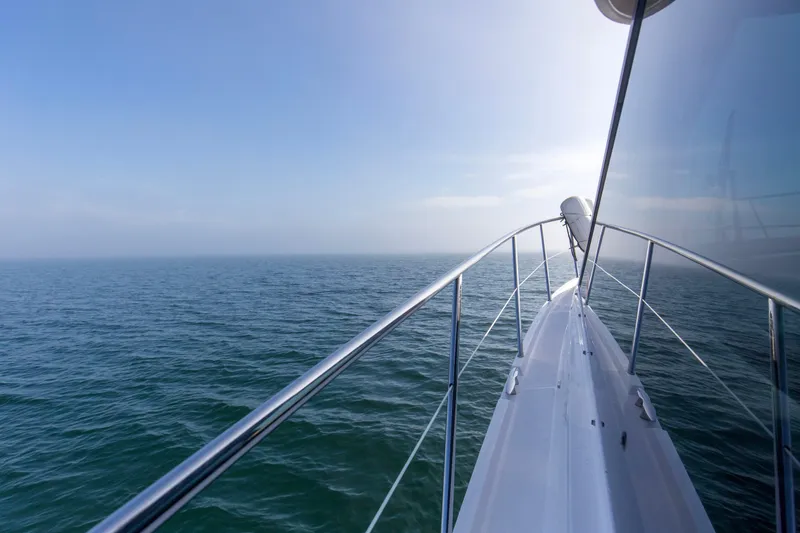 Slide: The Image of Bow view of 2020 Regal 38 XO yacht cruising on open sea. - 44