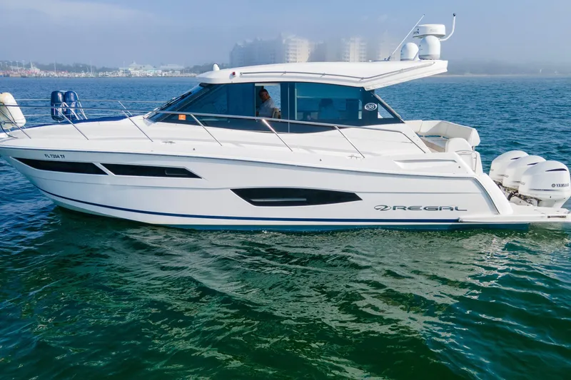 Slide: The Image of 2020 Regal 38 XO yacht cruising on calm waters, side view. - 46
