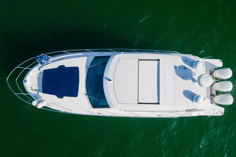 Slide: The Image of Aerial view of 2020 Regal 38 XO yacht on green water. - 47