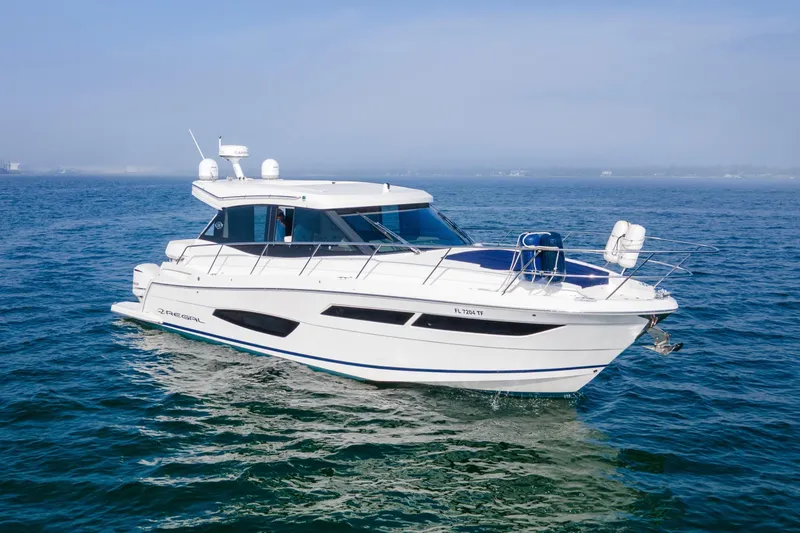 Slide: The Image of 2020 Regal 38 XO yacht cruising on open water under clear skies. - 48