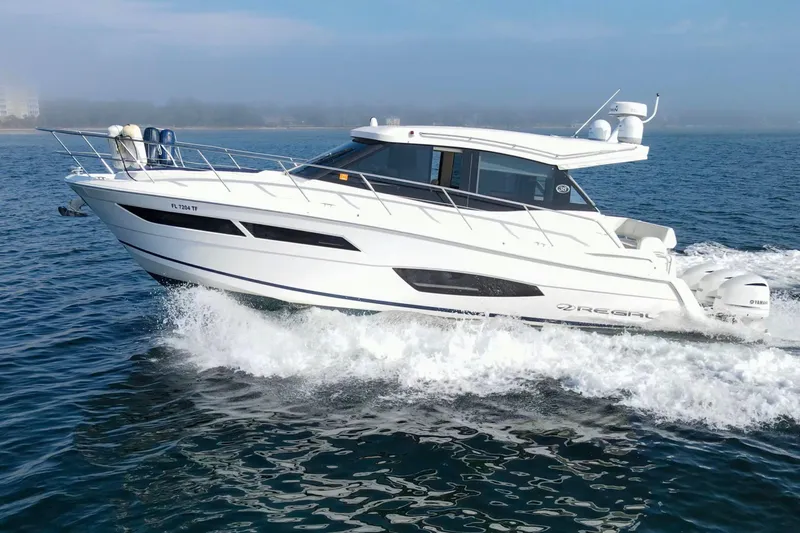 Slide: The Image of 2020 Regal 38 XO yacht cruising on open water, showcasing sleek design and powerful performance. - 52