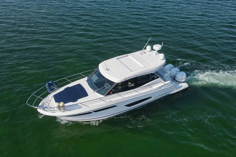 Slide: The Image of 2020 Regal 38 XO boat cruising on open water, aerial view. - 55