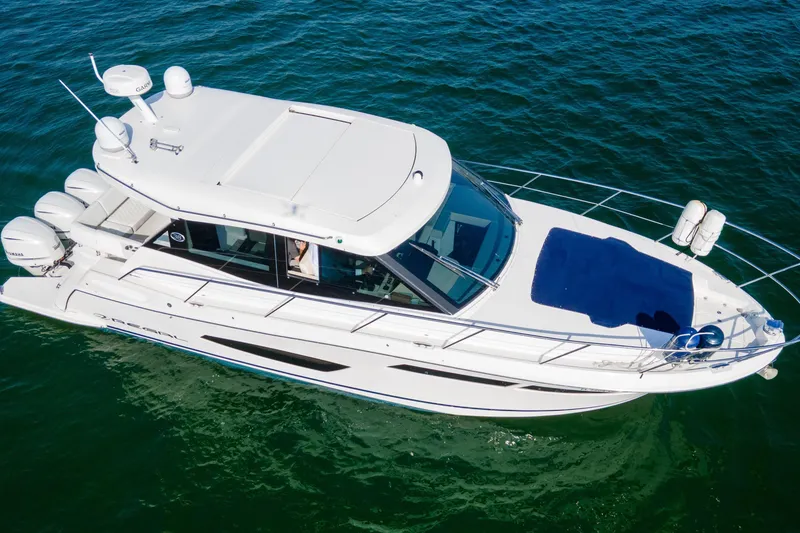 Slide: The Image of 2020 Regal 38 XO luxury yacht cruising on clear blue water. - 6