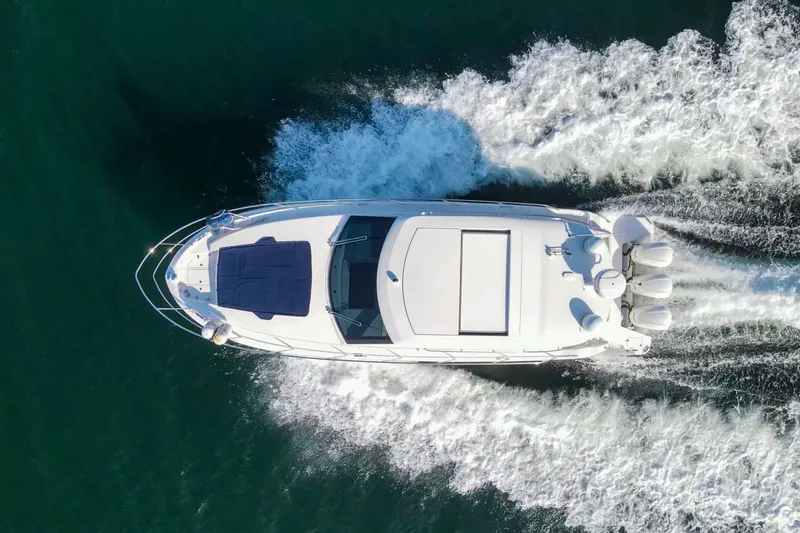 Slide: The Image of Aerial view of 2020 Regal 38 XO yacht cruising on open water. - 8