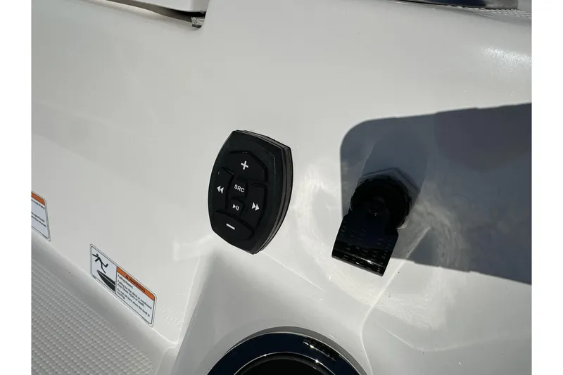 Slide: The Image of Control panel on 2023 Yamaha Boats 252 FSH Sport, featuring audio and source buttons. - 11