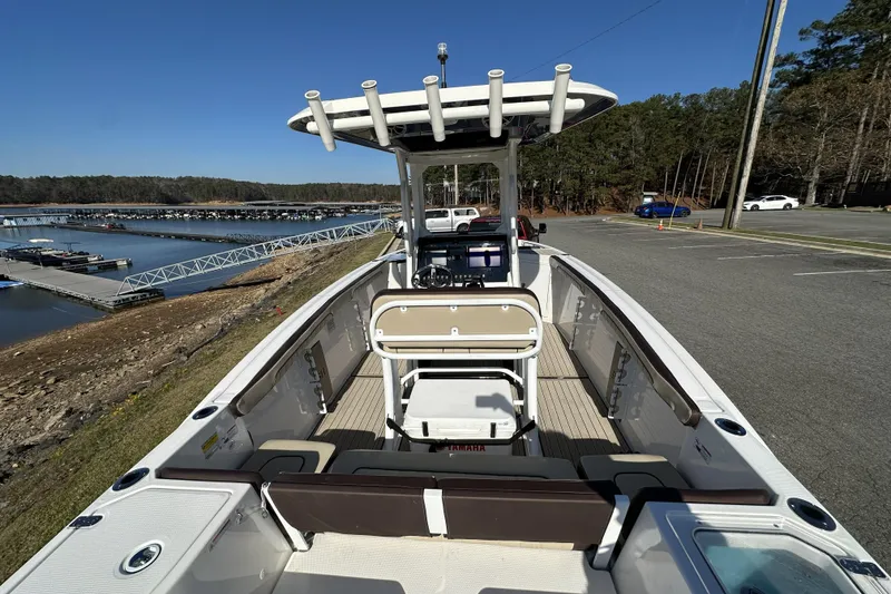 Slide: The Image of 2023 Yamaha Boats 252 FSH Sport at marina, showcasing interior and helm. - 13