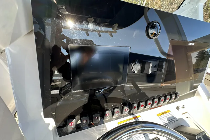 Slide: The Image of 2023 Yamaha Boats 252 FSH Sport dashboard with controls and display screens. - 17