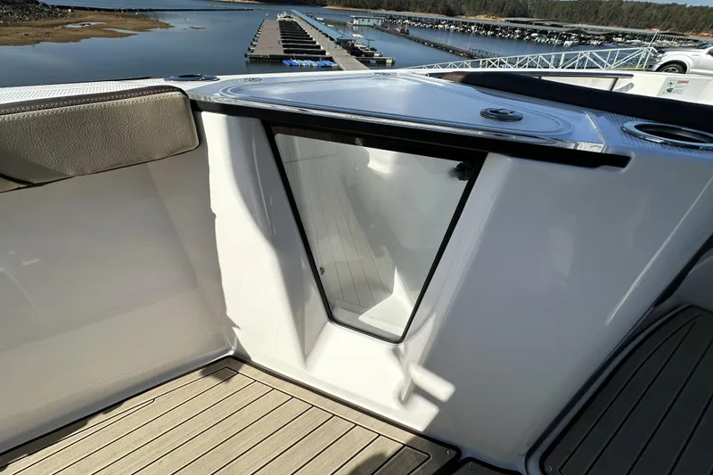Slide: The Image of 2023 Yamaha Boats 252 FSH Sport interior with sleek design and marina view. - 18