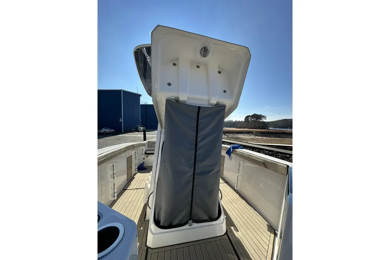 Slide: The Image of 2023 Yamaha Boats 252 FSH Sport interior view with open storage compartment. - 20