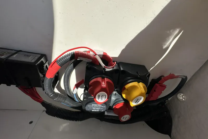 Slide: The Image of Electrical components inside 2023 Yamaha Boats 252 FSH Sport, featuring wiring and switches. - 28