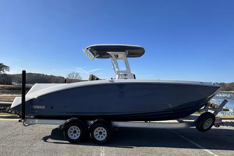 Slide: The Image of 2023 Yamaha Boats 252 FSH Sport on trailer, side view, outdoors. - 3