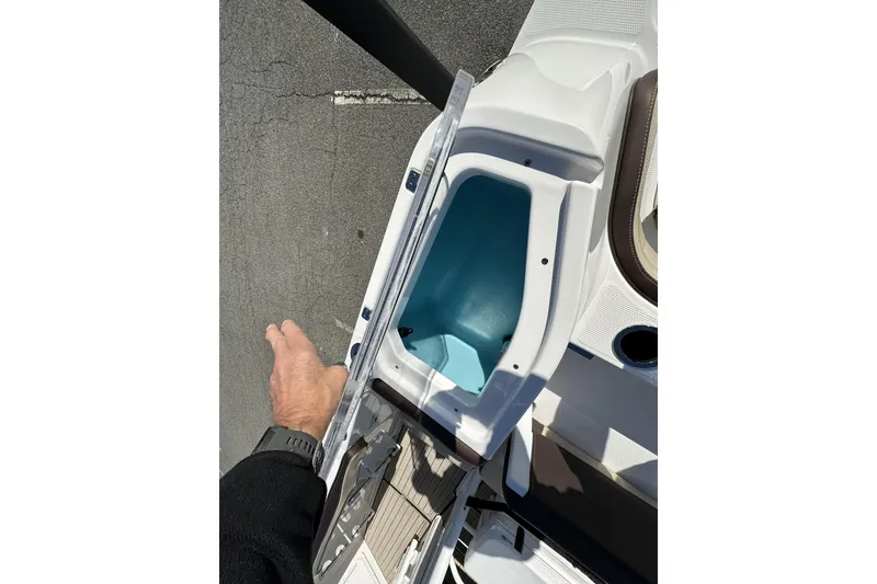 Slide: The Image of 2023 Yamaha Boats 252 FSH Sport storage compartment, open view from above. - 34