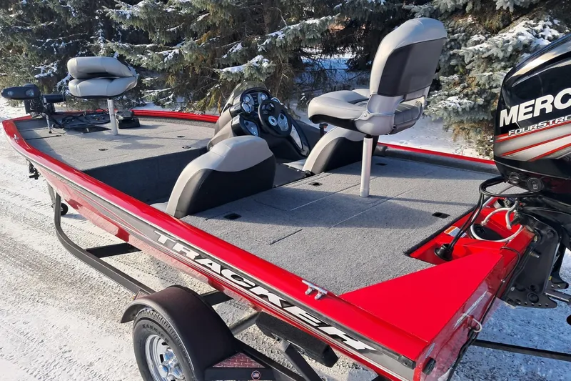Slide: The Image of 2018 Tracker Pro Team 175 TXW boat with Mercury engine, parked on snowy ground. - 3