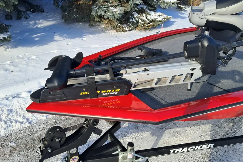 Slide: The Image of 2018 Tracker Pro Team 175 TXW boat with Minn Kota Ultrex trolling motor, parked on snowy ground. - 5
