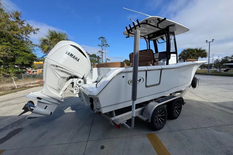 Slide: The Image of 2024 Sea Hunt Ultra 239 SE boat with Yamaha engine on trailer, outdoor setting. - 11