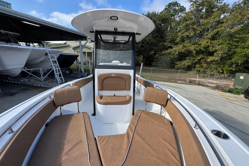 Slide: The Image of 2024 Sea Hunt Ultra 239 SE boat interior with brown seating and sleek design. - 21