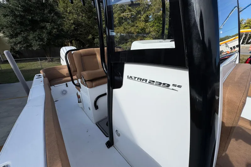 Slide: The Image of 2024 Sea Hunt Ultra 239 SE boat interior with seating and console details. - 23