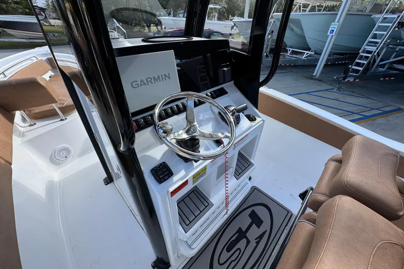 Slide: The Image of 2024 Sea Hunt Ultra 239 SE boat dashboard with Garmin navigation system. - 27