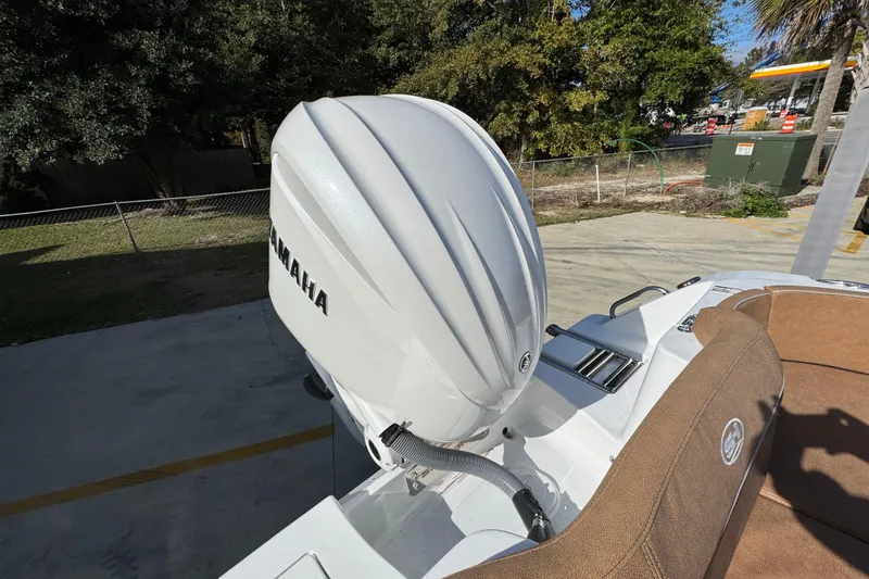 Slide: The Image of 2024 Sea Hunt Ultra 239 SE boat with Yamaha outboard motor, parked outdoors. - 39