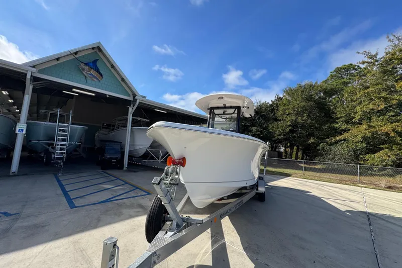 Slide: The Image of 2024 Sea Hunt Ultra 239 SE boat on trailer outside a storage facility. - 5