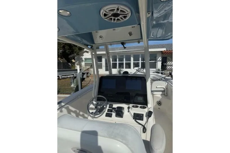 Slide: The Image of 2020 Cobia 280 Center Console boat interior with steering wheel and control panel. - 2