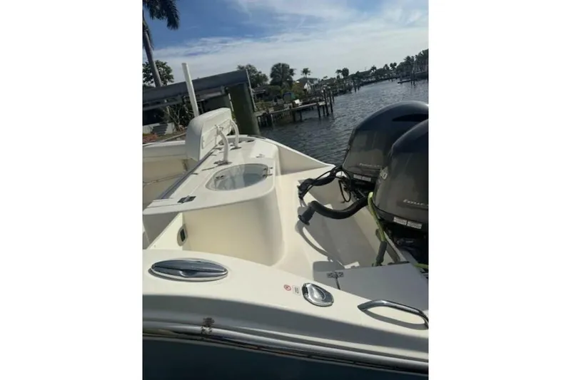 Slide: The Image of 2020 Cobia 280 Center Console boat with dual engines docked by the water. - 5