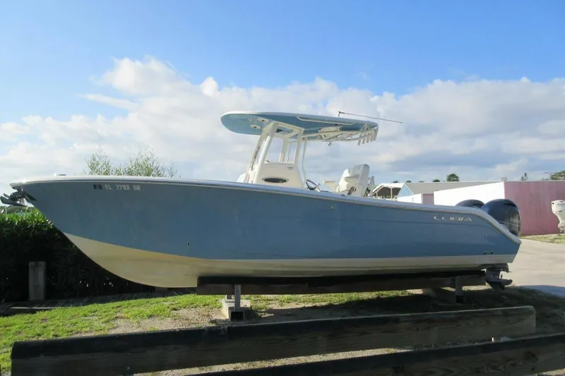 Slide: The Image of 2020 Cobia 280 Center Console boat on display under a clear blue sky. - 9