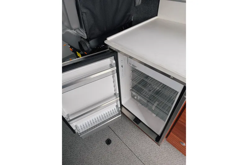 Slide: The Image of Open refrigerator in 2026 Hewescraft 290 Adventure boat interior. - 12