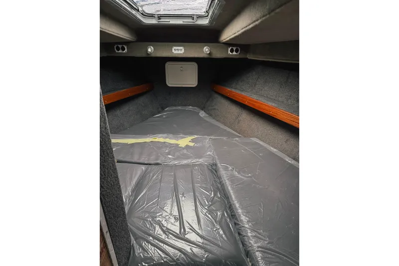 Slide: The Image of 2026 Hewescraft 290 Adventure cabin interior with skylight and wooden accents. - 13