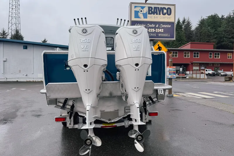 Slide: The Image of 2026 Hewescraft 290 Adventure with dual Yamaha 350 V6 outboard engines at a marine service center. - 4