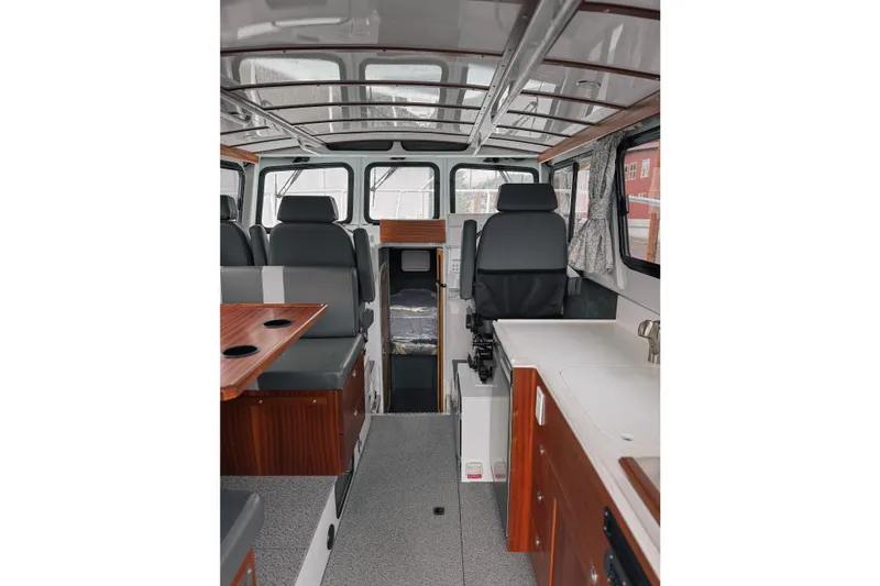 Slide: The Image of Interior of 2026 Hewescraft 290 Adventure boat, featuring seating and kitchenette. - 5