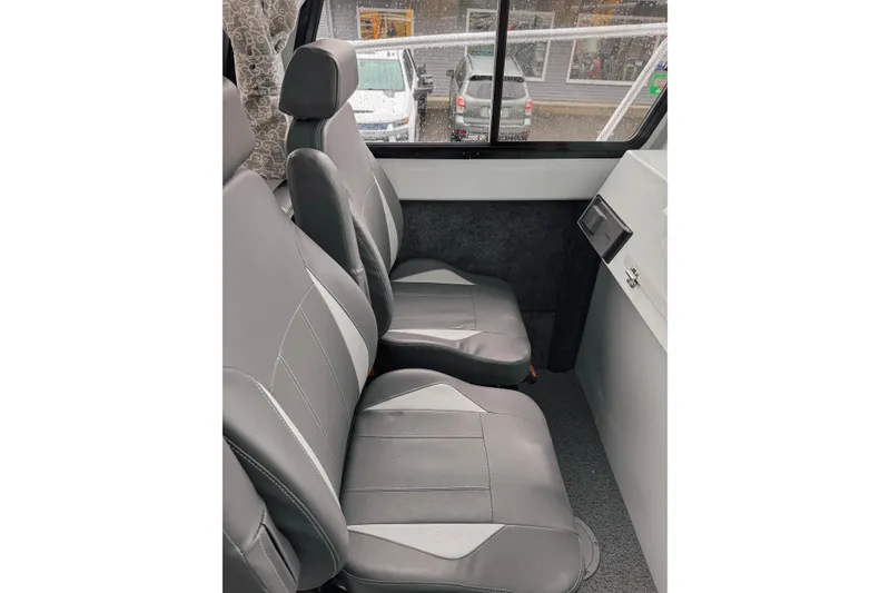 Slide: The Image of Interior seating of 2026 Hewescraft 290 Adventure boat, featuring sleek gray upholstery. - 7