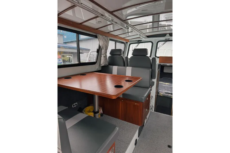 Slide: The Image of Interior of 2026 Hewescraft 290 Adventure boat with seating and wooden table. - 8