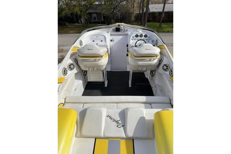 Slide: The Image of 2002 Donzi 38 Daytona boat interior with yellow and white seating, dashboard, and controls. - 10