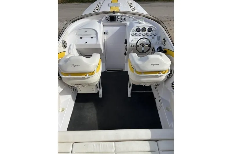 Slide: The Image of 2002 Donzi 38 Daytona boat cockpit with dual seats and steering wheel. - 12