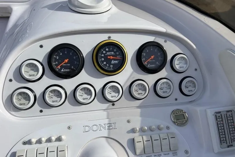 Slide: The Image of Dashboard of a 2002 Donzi 38 Daytona boat with gauges and controls. - 13