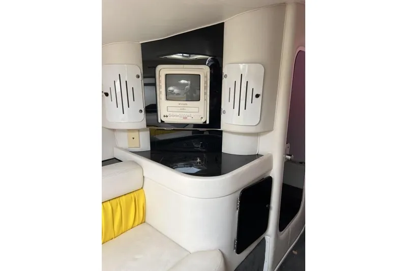 Slide: The Image of Interior of 2002 Donzi 38 Daytona boat with seating and built-in TV. - 16