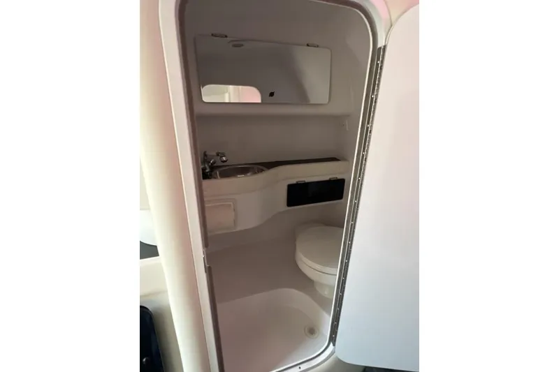 Slide: The Image of 2002 Donzi 38 Daytona boat bathroom interior with sink, toilet, and mirror. - 19