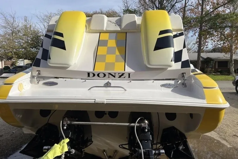 Slide: The Image of 2002 Donzi 38 Daytona boat with yellow and black checkered design, rear view. - 5