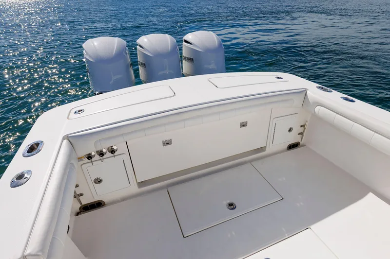 Slide: The Image of 2018 Regulator 34SS boat deck with triple outboard motors on calm water. - 11