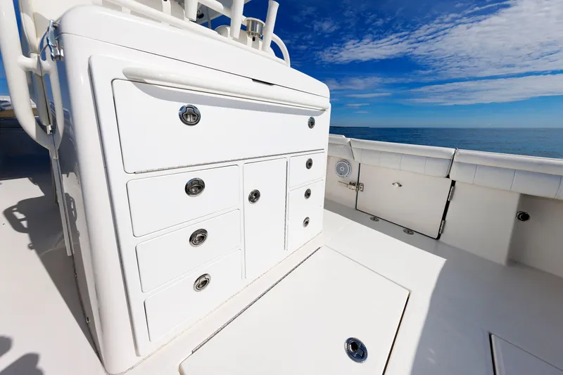 Slide: The Image of 2018 Regulator 34SS boat interior with storage compartments, ocean view, and clear sky. - 13