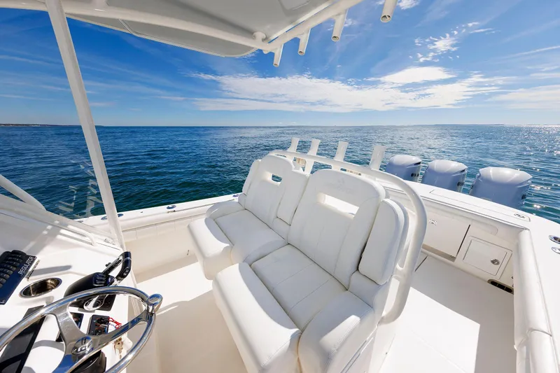 Slide: The Image of 2018 Regulator 34SS boat interior with white seating, ocean view, and clear blue sky. - 15
