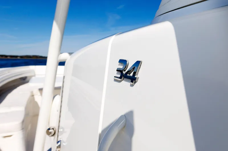 Slide: The Image of 2018 Regulator 34SS boat detail with chrome emblem against blue sky. - 20