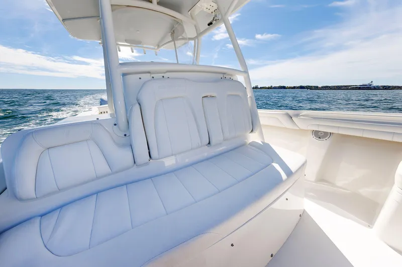 Slide: The Image of 2018 Regulator 34SS boat interior with white seating, ocean view, and clear sky. - 21