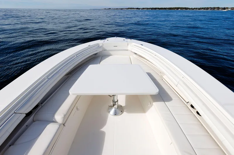 Slide: The Image of 2018 Regulator 34SS boat interior with seating and table on open water. - 22
