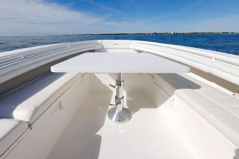 Slide: The Image of 2018 Regulator 34SS boat interior with white seating and table, ocean view. - 25