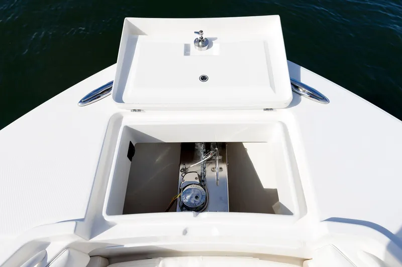 Slide: The Image of 2018 Regulator 34SS boat anchor compartment with open hatch, showing storage and hardware. - 27