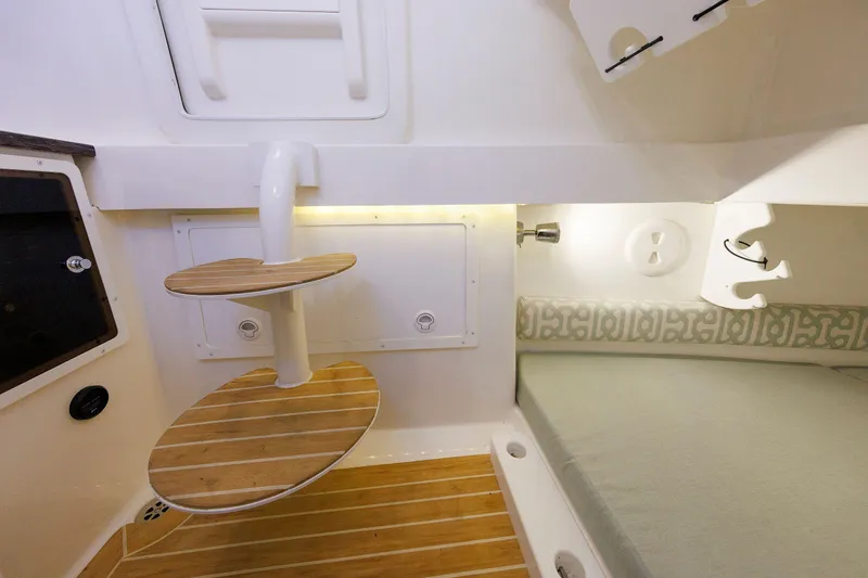 Slide: The Image of 2018 Regulator 34SS cabin interior with wooden steps and cushioned seating area. - 29