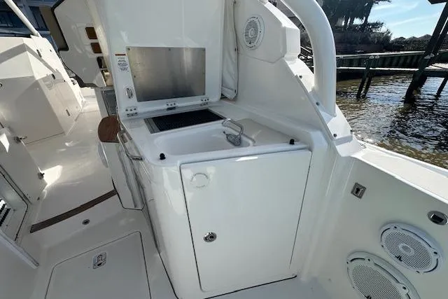 Slide: The Image of 2019 Pursuit DC 365 Dual Console boat with onboard kitchenette and sink. - 13